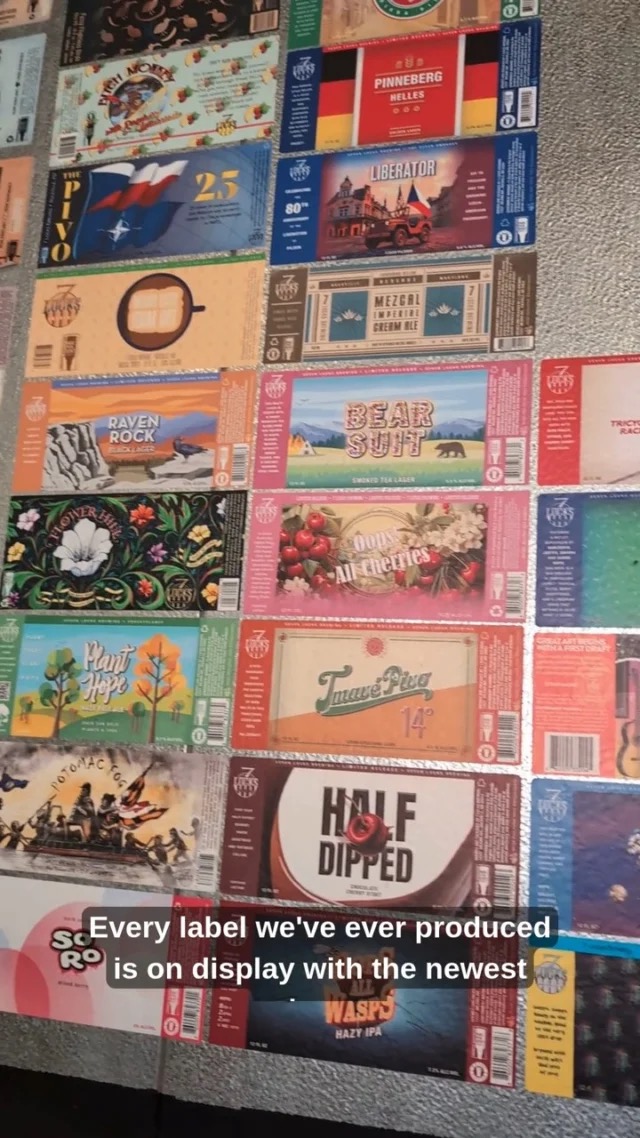Dozens of illustrated 7 Locks beer labels displayed edge to edge on the taproom wall